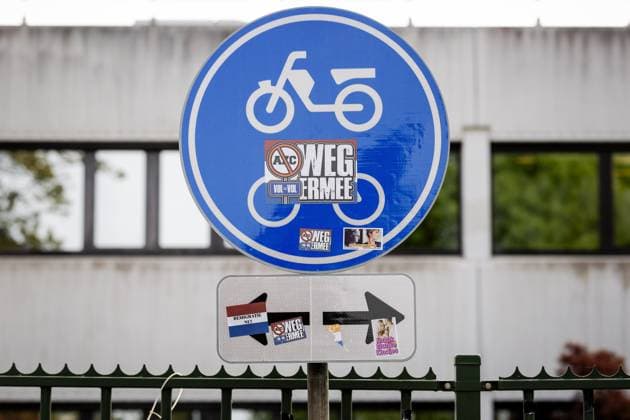 LOOSDRECHT - Stickers against an asylum seekers center on a traffic sign near the emergency shelter for asylum seekers in Loosdrecht. At that building, there was a protest by several hundred people demonstrating against the arrival of asylum seekers at that location. ROBIN VAN LONKHUIJSEN ANP netherlands out - belgium out  Copyright: xx x558145050x originalFilename: 558145050.jpg
