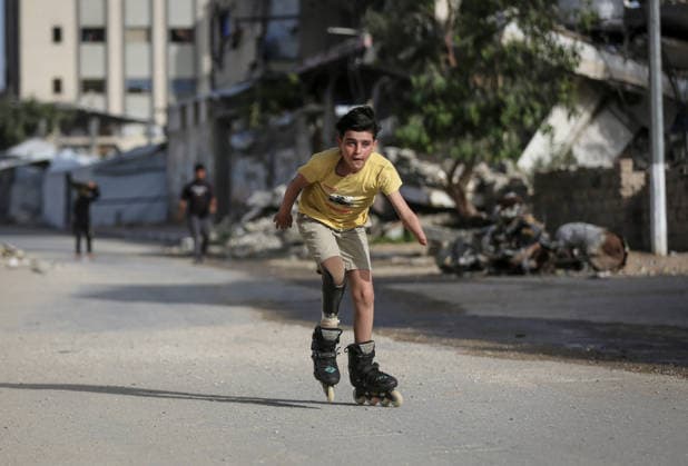 Gaza child who lost limbs in Israeli attacks holds onto life with skating GAZA CITY, GAZA, PALESTINE - MAY 12: Thirteen-year-old Akram al-Fayyumi, who lost his left arm and right foot in an Israeli attack on Gaza, skates on the streets of Gaza City, Gaza, Palestine on May 12, 2026. Akram is holding on to life through his passion for skating and horse riding. Despite using a prosthetic leg fitted in Egypt that he finds uncomfortable, he continues to skate. His only dream is to have a new prosthesis and a horse. Living in the Tel al-Hawa area of Gaza City, Akram says that skating is his greatest source of happiness. Saeed M. M. T. Jaras Anadolu Gaza City Gaza. Editorial use only. Please get in touch for any other usage.  Copyright: x2026xAnadoluxSaeedxM.xM.xT.xJarasx