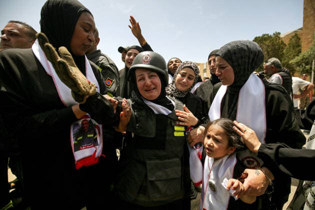 May 13, 2026, Sidon, Sidon, Lebanon: Wife of Lebanese civil defense member Ahmad Noura, wearing the bulletproof jacket, helmet and gloves of her husband, mourns during his funeral procession of her husband in the southern port city of Sidon. Noura and his colleague Hussein Jaber were killed in an Israeli air strike in south Lebanon. Israel has kept up its airstrikes against the Iran-backed militant group Hezbollah despite a truce in place since April 17 aimed at halting the fighting. The violence comes with Lebanon and Israel due to hold a new round of direct negotiations in Washington on Thursday, brokered by the United States. Sidon Lebanon - ZUMAn313 20260513_zip_n313_005 Copyright: xMarwanxNaamanix