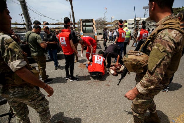 May 13, 2026, Sidon, Sidon, Lebanon: Lebanese soldiers secure the area as civil defense members collect remain of human body after an Israeli drone struck a vehicle at the entrance of the southern port city of Sidon. Israel has kept up its airstrikes against the Iran-backed militant group Hezbollah despite a truce in place since April 17 aimed at halting the fighting. The violence comes with Lebanon and Israel due to hold a new round of direct negotiations in Washington on Thursday, brokered by the United States. Sidon Lebanon  - ZUMAn313 20260513_zip_n313_002 Copyright: xMarwanxNaamanix