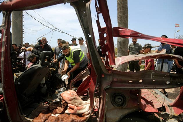 May 13, 2026, Sidon, Sidon, Lebanon: A civil defense member inspects wreckage of a vehicle that was targeted in an Israeli drone at the entrance of the southern port city of Sidon. Israel has kept up its airstrikes against the Iran-backed militant group Hezbollah despite a truce in place since April 17 aimed at halting the fighting. The violence comes with Lebanon and Israel due to hold a new round of direct negotiations in Washington on Thursday, brokered by the United States. Sidon Lebanon  - ZUMAn313 20260513_zip_n313_003 Copyright: xMarwanxNaamanix