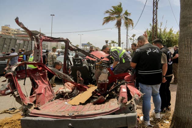 May 13, 2026, Sidon, Sidon, Lebanon: A civil defense member inspects wreckage of a vehicle that was targeted in an Israeli drone at the entrance of the southern port city of Sidon. Israel has kept up its airstrikes against the Iran-backed militant group Hezbollah despite a truce in place since April 17 aimed at halting the fighting. The violence comes with Lebanon and Israel due to hold a new round of direct negotiations in Washington on Thursday, brokered by the United States. Sidon Lebanon  - ZUMAn313 20260513_zip_n313_004 Copyright: xMarwanxNaamanix