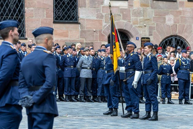 Public pledge of the Bundeswehr on Sebalder Platz, Nuremberg, 13 05 2026 Flag bearer with troop flag and federal eagle stands with accompanying officers after the ceremonial pledge in front of the recruits and numerous spectators Nuremberg Bavaria Germany 20260513-1V9A8220-M4000