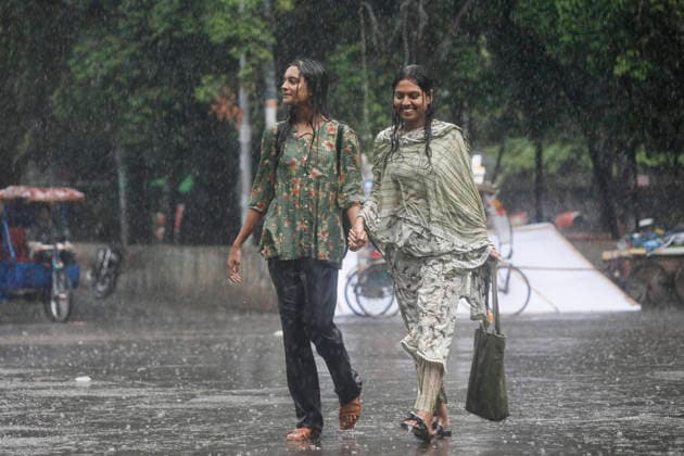 May 13, 2026, Dhaka, Bangladesh: Two girls enjoy the rain at the TSC area of the University of Dhaka in Dhaka, Bangladesh, on May 13, 2026, as heavy showers swept across the capital. Dhaka Bangladesh - ZUMAh355 20260513_zip_h355_037 Copyright: xMd.xRakibulxHasanxRafiux