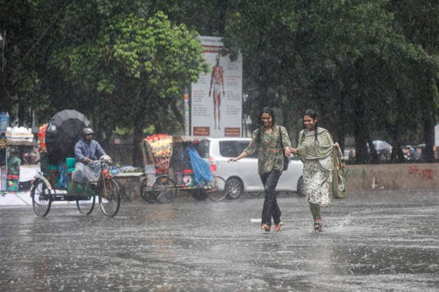 May 13, 2026, Dhaka, Bangladesh: Two girls enjoy the rain at the TSC area of the University of Dhaka in Dhaka, Bangladesh, on May 13, 2026, as heavy showers swept across the capital. Dhaka Bangladesh - ZUMAh355 20260513_zip_h355_038 Copyright: xMd.xRakibulxHasanxRafiux