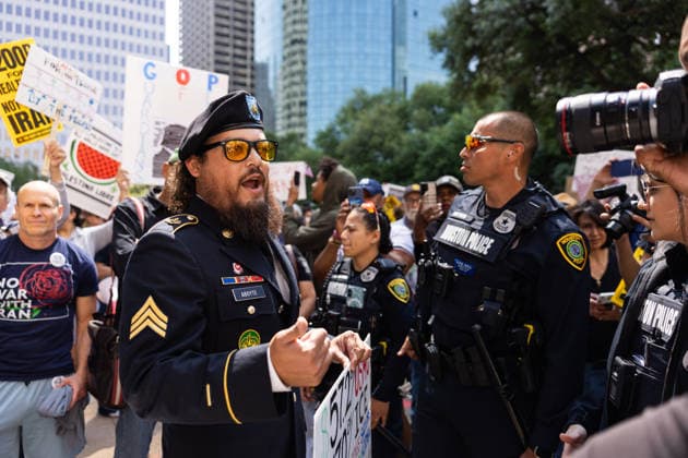 May 13, 2026, Houston, Texas, USA: During a No Kings protest at Houston City Hall in Houston, a demonstrator, Sgt. ABOYTE, who served in the U.S. Marine Corps and U.S. Army, speaks with the Houston police about his representation. Houston USA  - ZUMA 20260513_mda_g287_014 Copyright: xMatthewxGuzmanx