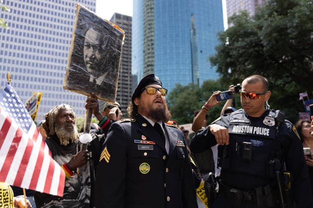 May 13, 2026, Houston, Texas, USA: During a No Kings protest at Houston City Hall in Houston, a demonstrator, Sgt. ABOYTE, who served in the U.S. Marine Corps and U.S. Army, speaks with the Houston police about his representation. Houston USA  - ZUMA 20260513_mda_g287_016 Copyright: xMatthewxGuzmanx