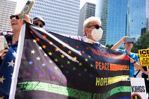 May 13, 2026, Houston, Texas, USA: During a No Kings protest at Houston City Hall in Houston, a demonstrator holds up a flag. Houston USA  - ZUMA 20260513_mda_g287_018 Copyright: xMatthewxGuzmanx