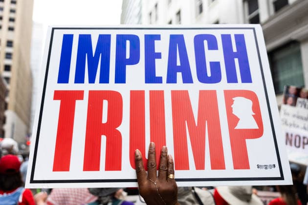 May 13, 2026, Houston, Texas, USA: During a No Kings protest in downtown Houston, a demonstrator holds up a sign reading Impeach Trump. Houston USA - ZUMA 20260513_mda_g287_002 Copyright: xMatthewxGuzmanx
