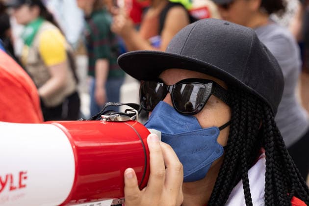 May 13, 2026, Houston, Texas, USA: During a No Kings protest in downtown Houston, a demonstrator shouts through a megaphone. Houston USA - ZUMA 20260513_mda_g287_005 Copyright: xMatthewxGuzmanx