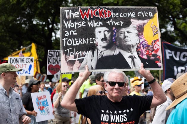 May 13, 2026, Houston, Texas, USA: During a No Kings protest in downtown Houston, demonstrators march holding up signs. Houston USA - ZUMA 20260513_mda_g287_009 Copyright: xMatthewxGuzmanx
