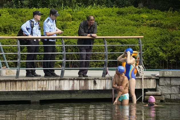 Tightened security in Beijing Security officers speak to people in Beijing on May 14, 2026, during a patrol ahead of a summit between U.S. President Donald Trump and his Chinese counterpart Xi Jinping the same day.  A14AA0005554803P