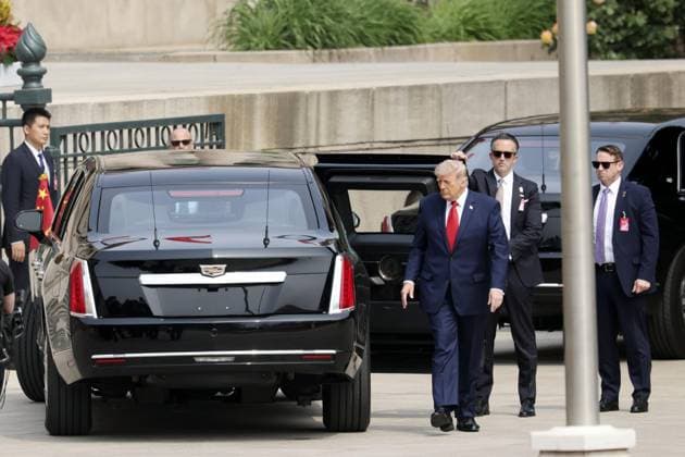 U.S.-China summit in Beijing U.S. President Donald Trump (front), arrives at the Great Hall of the People in Beijing for a summit meeting with Chinese President Xi Jinping on May 14, 2026. (Pool photo)  A14AA0005555098P