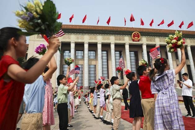 U.S.-China summit in Beijing Children wave U.S. and Chinese flags in front of the Great Hall of the People in Beijing ahead of a summit meeting between U.S. President Donald Trump and Chinese President Xi Jinping on May 14, 2026. (Pool photo)  A14AA0005555143P