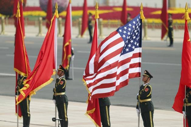 U.S.-China summit in Beijing A Chinese People s Liberation Army honor guard holds a U.S. national flag during a welcoming ceremony for U.S. President Donald Trump at the Great Hall of the People in Beijing on May 14, 2026, ahead of a summit meeting between Trump and Chinese President Xi Jinping. (Pool photo)  A14AA0005555388P