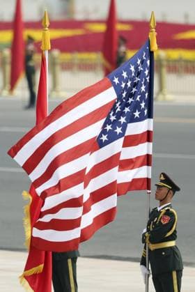 U.S.-China summit in Beijing A Chinese People s Liberation Army honor guard holds a U.S. national flag during a welcoming ceremony for U.S. President Donald Trump at the Great Hall of the People in Beijing on May 14, 2026, ahead of a summit meeting between Trump and Chinese President Xi Jinping. (Pool photo)  A14AA0005555390P