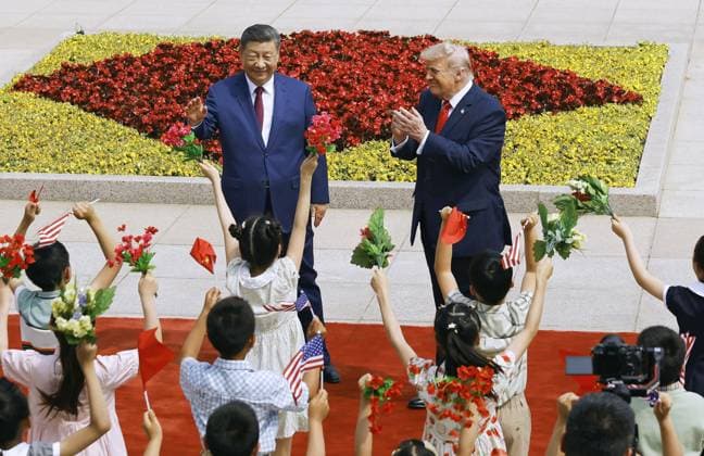 U.S. President Trump in Beijing U.S. President Donald Trump (R), alongside Chinese President Xi Jinping, is welcomed by children during a welcome ceremony at the Great Hall of the People in Beijing on May 14, 2026. (Pool photo)  A14AA0005556263P
