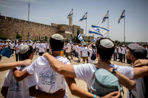 Jerusalem Day Flag Parade Israeli right wing youths wave their national flags and dance outside Jafa gate In Jerusalem, Thursday May 14 2026. Israeli nationalists, many of them teenagers and young adults, swept through the narrow streets of JerusalemÕs Old City on Thursday during the annual Jerusalem Day march, chanting ÒDeath to ArabsÓ and ÒMay your villages burnÓ as tens of thousands paraded to celebrate what Israeli authorities call the ÒreunificationÓ of Jerusalem following IsraelÕs capture and annexation of east Jerusalem in the 1967 Arab-Israeli war, while many Palestinian residents remained barricaded indoors and shopkeepers were forced, ostensibly for their own protection, to close their businesses. Photo by Eyal Warshavsky. Jerusal Copyright: xEyalxWarshavskyx
