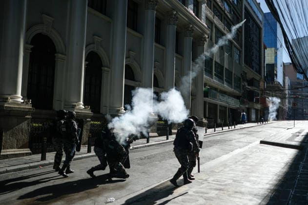 Miners attempt to break through police cordon in La Paz LA PAZ, BOLIVIA - MAY 14: A group of police officers fire tear gas during clashes with police as mining cooperatives protested to demand fuel supplies, access to explosives and improved mining conditions in downtown La Paz, Bolivia, on May 14, 2026. Carlos Sanchez Navas Anadolu La Paz Bolivia. Editorial use only. Please get in touch for any other usage.  Copyright: x2026xAnadoluxCarlosxSanchezxNavasx