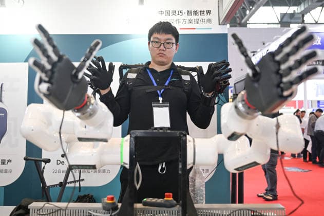 HANGZHOU, CHINA - MAY 14: A staff member operates a robotic arm to perform various movements during the 2nd Hangzhou International Humanoid Robot and Robot Technology Exhibition 2026 on May 14, 2026 in Hangzhou, Zhejiang Province of China.  Copyright: xChinaxNewsxServicex 111641446838