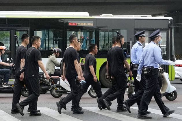 Tightened security in Beijing Police officers patrol Beijing on May 15, 2026, amid heightened security during the second day of summit talks between U.S. President Donald Trump and Chinese President Xi Jinping.  A14AA0005560130P