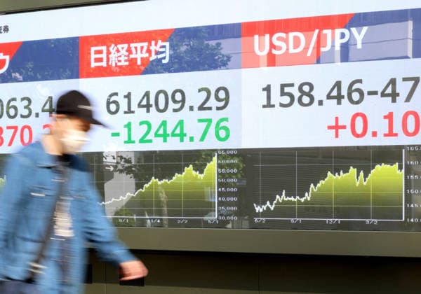 May 15, 2026, Tokyo, Japan - A pedestrian passes before a share prices board in Tokyo on Friday, May 15, 2026. Japan s share prices fell 1244.76 yen to close at 61,409.29 yen at the Tokyo Stock Exchange, while the US dollar is traded at 158 yen level against Japanese yen at the Tokyo forex market. (photo by Yoshio Tsunoda AFLO)  aflo_330468179