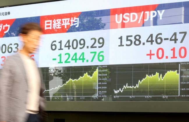 May 15, 2026, Tokyo, Japan - A pedestrian passes before a share prices board in Tokyo on Friday, May 15, 2026. Japan s share prices fell 1244.76 yen to close at 61,409.29 yen at the Tokyo Stock Exchange. (photo by Yoshio Tsunoda AFLO)  aflo_330468184