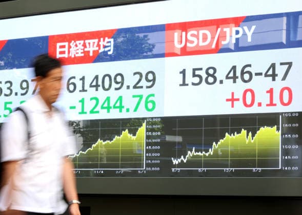 May 15, 2026, Tokyo, Japan - A pedestrian passes before a share prices board in Tokyo on Friday, May 15, 2026. Japan s share prices fell 1244.76 yen to close at 61,409.29 yen at the Tokyo Stock Exchange, while the US dollar is traded at 158 yen level against Japanese yen at the Tokyo forex market. (photo by Yoshio Tsunoda AFLO)  aflo_330468185