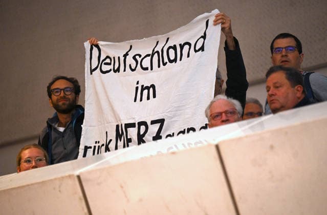 Protests with banner Germany in the backMERZgang at a panel event on Shaping the future together with Chancellor Friedrich Copyright: epd-bild DanielxPeter epd-Katholikentag_Wuerzburg89-kopieren.jpeg