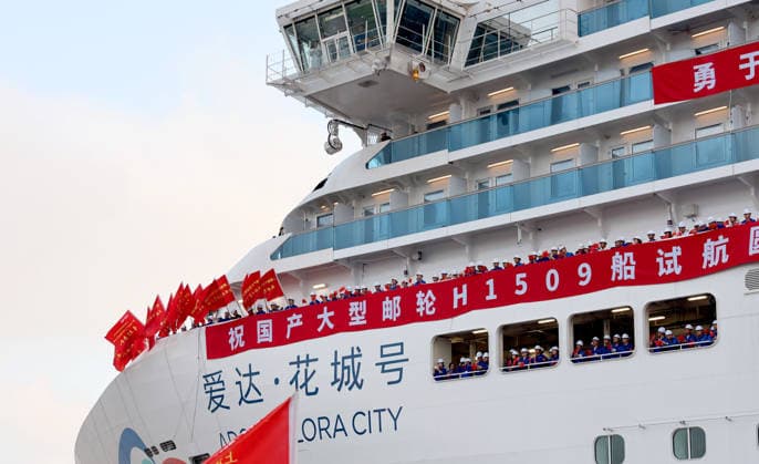 (260516) -- SHANGHAI, May 16, 2026 -- Technicians participating in a sea trial of the cruise ship Adora Flora City waves on the bow deck in Shanghai, east China, May 16, 2026. Adora Flora City, China s second domestically built large cruise ship, departed from Shanghai on Saturday for a 12-day sea trial. A total of 937 engineering and technical personnel from 12 countries participated in this trial voyage. The 341-meter-long vessel, with a gross tonnage of 141,900 tonnes, has 2,130 cabins and suites and can carry up to 5,232 passengers at full capacity. It is scheduled to be delivered on Nov. 6, 2026, and will begin its inaugural season from the Nansha International Cruise Home Port in Guangzhou, capital of south China s Guangdong Pr