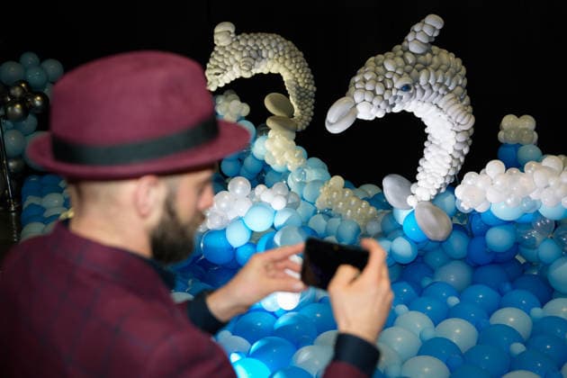 (260516) -- WARSAW, May 16, 2026 -- A visitor takes photos of dolphin-themed balloon installations during the World Balloon Festival in Warsaw, Poland, May 15, 2026. The festival takes place here from May 15 to 17, featuring large themed installations featuring tropical jungles, underwater world, outer space and architectural landmarks created with more than 100,000 biodegradable balloons. (Photo by Xinhua) POLAND-WARSAW-WORLD BALLOON FESTIVAL JaapxArriens 