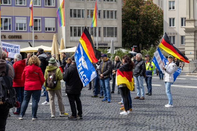 Augsburg, Bavaria, Germany May 16, 2026: Demonstration in Augsburg against the current federal government led by Chancellor Friedrich Merz. The slogan: Merz must go! Demonstrators carrying German flags