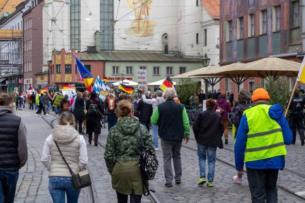 Augsburg, Bavaria, Germany May 16, 2026: Demonstration in Augsburg against the current federal government led by Chancellor Friedrich Merz. The slogan: Merz must go! Demonstrators carrying German flags