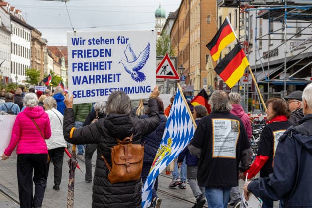 Augsburg, Bavaria, Germany May 16, 2026: Demonstration in Augsburg against the current federal government led by Chancellor Friedrich Merz. Under the slogan: Merz must go! Participant holding a sign banner: We stand for PEACE, FREEDOM, TRUTH, SELF-DETERMINATION