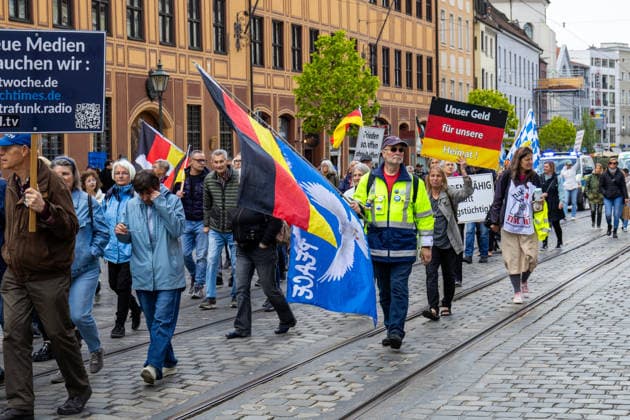 Augsburg, Bavaria, Germany May 16, 2026: Demonstration in Augsburg against the current federal government led by Chancellor Friedrich Merz. The slogan: Merz must go! Demonstrators carrying German flags