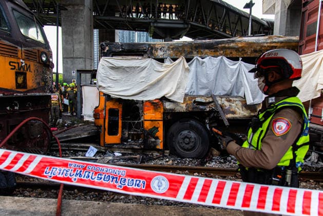 May 16, 2026, Bangkok, Thailand: A police officer seen inspects a burnt public bus after it collides with a cargo train at the Makkasan airport rail link station. At least 8 people were killed and more than 25 people injured in the accident. Bangkok Thailand - ZUMAs197 20260516_aaa_s197_084 Copyright: xPeeraponxBoonyakiatx