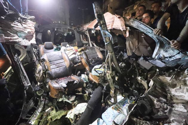 Destroyed Car Al-Nasr Street Gaza City People stand next to the wreckage of a vehicle, targeted on Al-Nasr Street in Gaza City, Gaza Strip, on May 16, 2026. Gaza Gaza Strip Palestinian Territories Copyright: xAhmedxAlxArinix