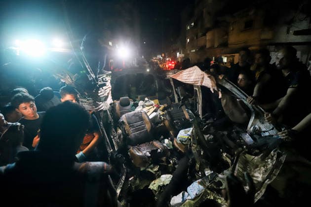 Destroyed Car Al-Nasr Street Gaza City People gather, some holding flashlights, around the wreckage of a vehicle, targeted on Al-Nasr Street in Gaza City, Gaza Strip, on May 16, 2026. Gaza Gaza Strip Palestinian Territories Copyright: xAhmedxAlxArinix