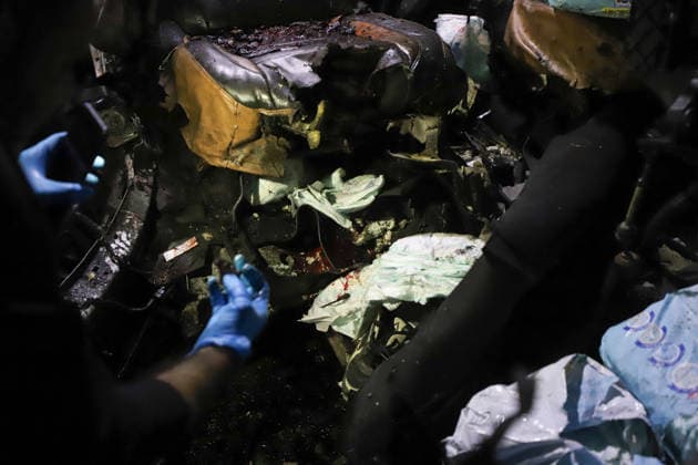 Destroyed Car Al-Nasr Street Gaza City A person wearing blue gloves inspects debris and bloodstains inside a severely damaged vehicle, targeted on Al-Nasr Street in Gaza City, Gaza Strip, on May 16, 2026. Gaza Gaza Strip Palestinian Territories Copyright: xAhmedxAlxArinix