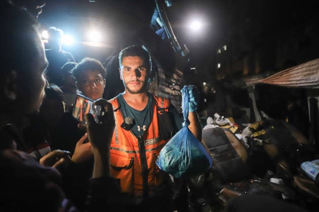 Destroyed Car Al-Nasr Street Gaza City A Civil Defense worker holds a plastic bag near the wreckage of a vehicle, targeted on Al-Nasr Street in Gaza City, Gaza Strip, on May 16, 2026. Gaza Gaza Strip Palestinian Territories Copyright: xAhmedxAlxArinix