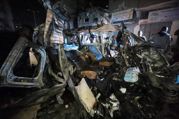 Destroyed Car Al-Nasr Street Gaza City People gather around the wreckage of a vehicle, targeted on Al-Nasr Street in Gaza City, Gaza Strip, on May 16, 2026. Gaza Gaza Strip Palestinian Territories Copyright: xAhmedxAlxArinix