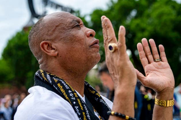 Dwight Butler from Lynchburg, Virginia prays during Rededicate 250 on the National Mall in Washington, DC on Sunday, May 17, 2026. The event, organized by Freedom 250 and the White House Faith Office, will feature political and faith leaders honoring 250 years of American history and encourage prayer or the country s next 250 years.  WAP20260517322 BONNIExCASH