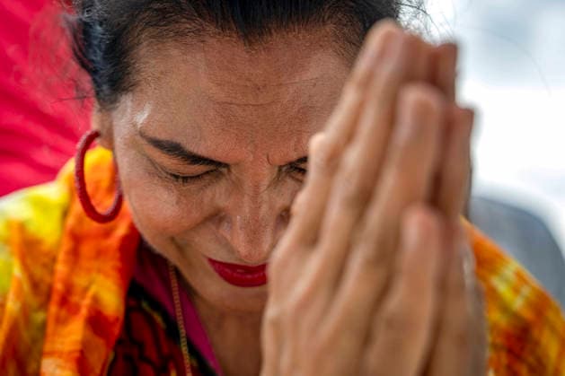 A woman prays worships Rededicate 250 on the National Mall in Washington, DC on Sunday, May 17, 2026. The event, organized by Freedom 250 and the White House Faith Office, will feature political and faith leaders honoring 250 years of American history and encourage prayer or the country s next 250 years.  WAP20260517323 BONNIExCASH