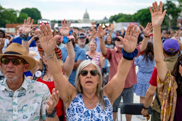 People worship during Rededicate 250 on the National Mall in Washington, DC on Sunday, May 17, 2026. The event, organized by Freedom 250 and the White House Faith Office, will feature political and faith leaders honoring 250 years of American history and encourage prayer or the country s next 250 years.  WAP20260517325 BONNIExCASH