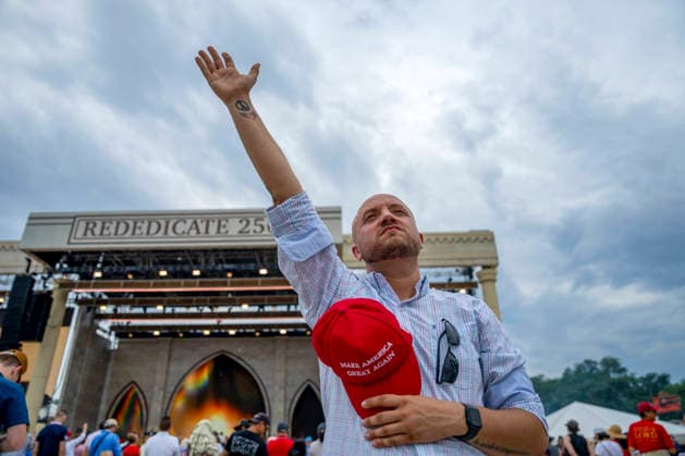 A man holding a MAGA hat worships during Rededicate 250 on the National Mall in Washington, DC on Sunday, May 17, 2026. The event, organized by Freedom 250 and the White House Faith Office, will feature political and faith leaders honoring 250 years of American history and encourage prayer or the country s next 250 years.  WAP20260517330 BONNIExCASH