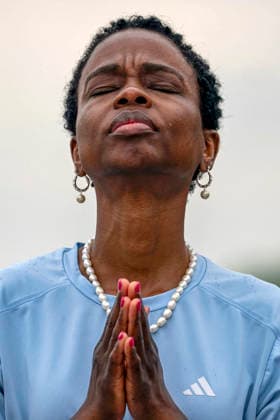 A woman worships during Rededicate 250 on the National Mall in Washington, DC on Sunday, May 17, 2026. The event, organized by Freedom 250 and the White House Faith Office, will feature political and faith leaders honoring 250 years of American history and encourage prayer or the country s next 250 years.  WAP20260517336 BONNIExCASH