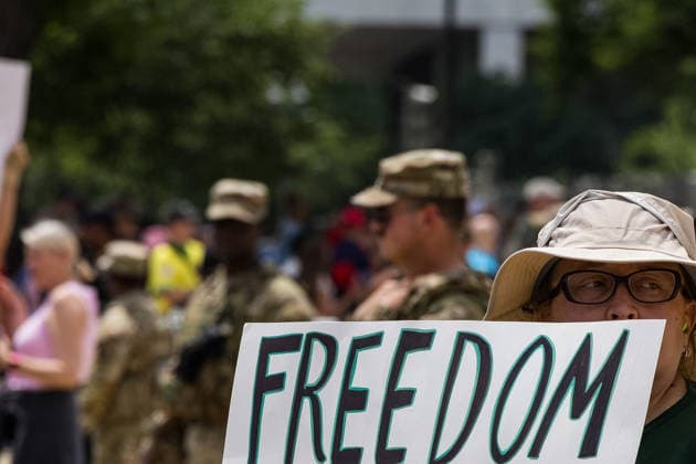 May 17, 2026, Washington, District Of Columbia, USA: A protester holds a sign in front of armed National Guard soldiers outside the Ã¢â‚¬oeRededicate 250Ã¢â‚¬Â event on the National Mall. Washington USA - ZUMAh196 20260517_znp_h196_016 Copyright: xTomxHudsonx