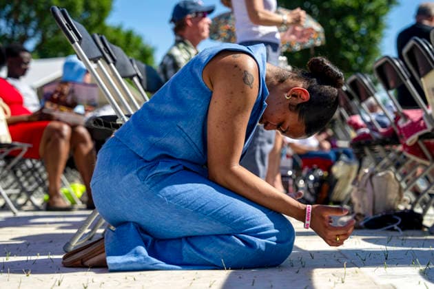 A woman worships during Rededicate 250 on the National Mall in Washington, DC on Sunday, May 17, 2026. The event, organized by Freedom 250 and the White House Faith Office, will feature political and faith leaders honoring 250 years of American history and encourage prayer or the country s next 250 years.  WAP20260517347 BONNIExCASH