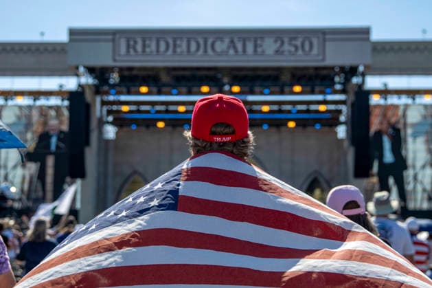 A man holds an American flag and wears a Trump hat while attending Rededicate 250 on the National Mall in Washington, DC on Sunday, May 17, 2026. The event, organized by Freedom 250 and the White House Faith Office, will feature political and faith leaders honoring 250 years of American history and encourage prayer or the country s next 250 years.  WAP20260517360 BONNIExCASH