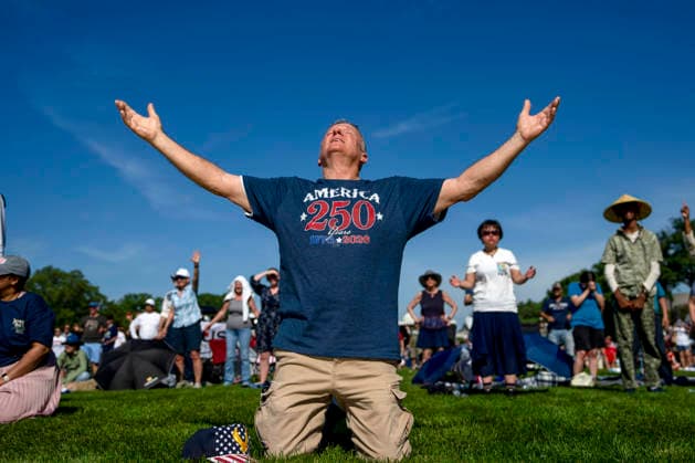 Teddy May from Mobile, Alabama prays during Rededicate 250 on the National Mall in Washington, DC on Sunday, May 17, 2026. The event, organized by Freedom 250 and the White House Faith Office, will feature political and faith leaders honoring 250 years of American history and encourage prayer or the country s next 250 years.  WAP20260517356 BONNIExCASH